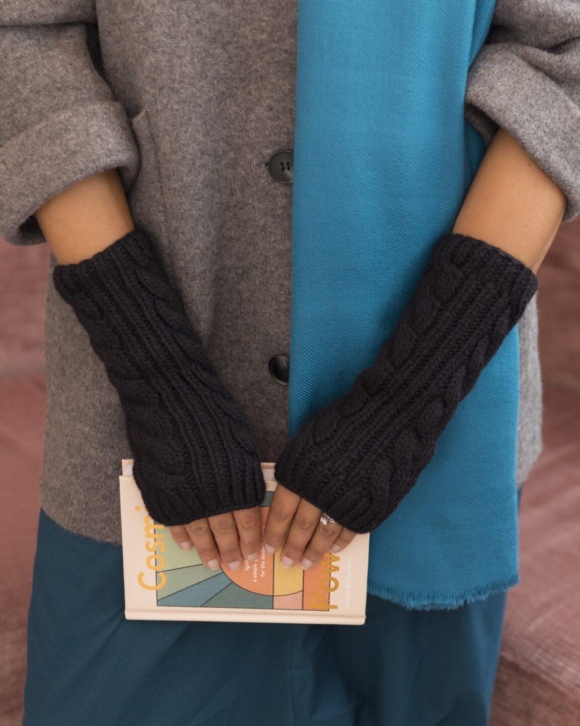 Black merino wool fingerless gloves, hand-knitted by likemary, ideal for sustainable fashion, winter warmth, and practical use.